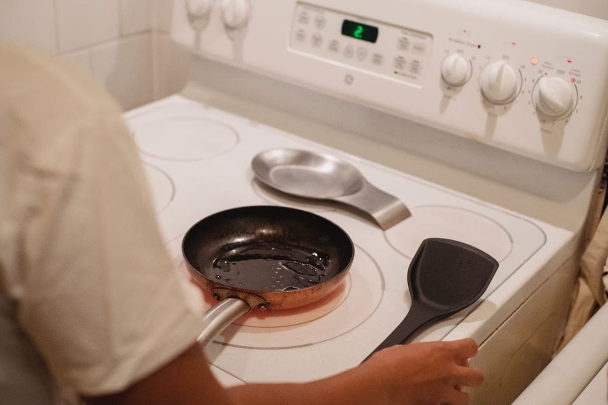 A carbon steel pan and a cast iron skillet side by side